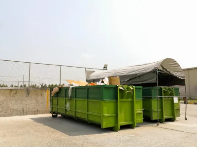 Business waste removal team collecting commercial rubbish from a local shop in the UK