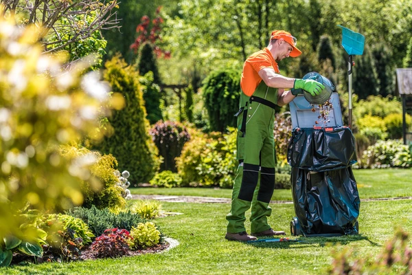 Garden waste including branches, leaves, and soil being removed by a professional team in Sale